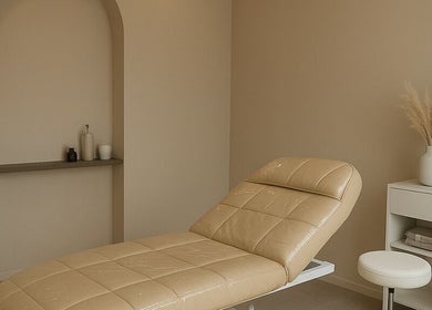 Elegant beige treatment room at 23 Aesthetic Studio, Southend-on-sea, England, GB, featuring a stylish treatment bed.