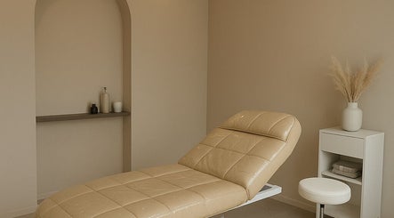 Elegant beige treatment room at 23 Aesthetic Studio, Southend-on-sea, England, GB, featuring a stylish treatment bed.