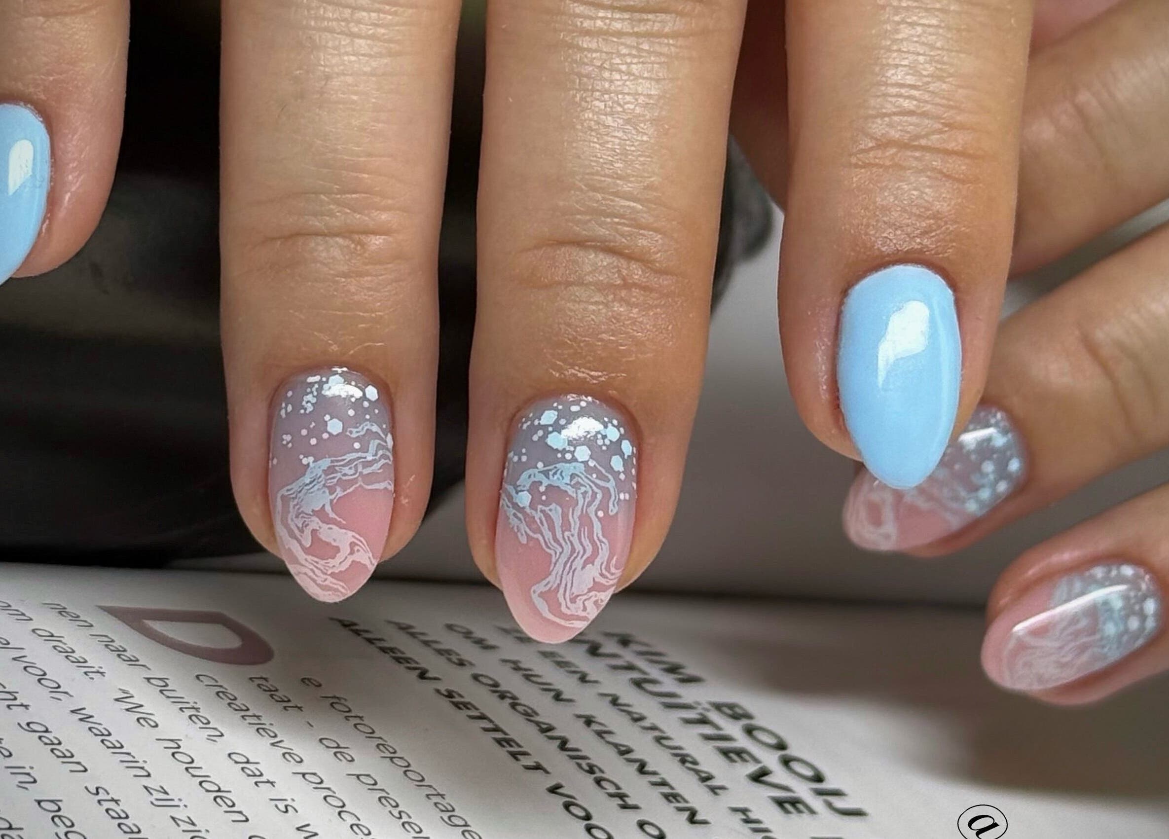 Intricate nail art at Daria Art & Grace Nail Studio, Eindhoven, Noord-brabant, NL featuring blue and white designs.
