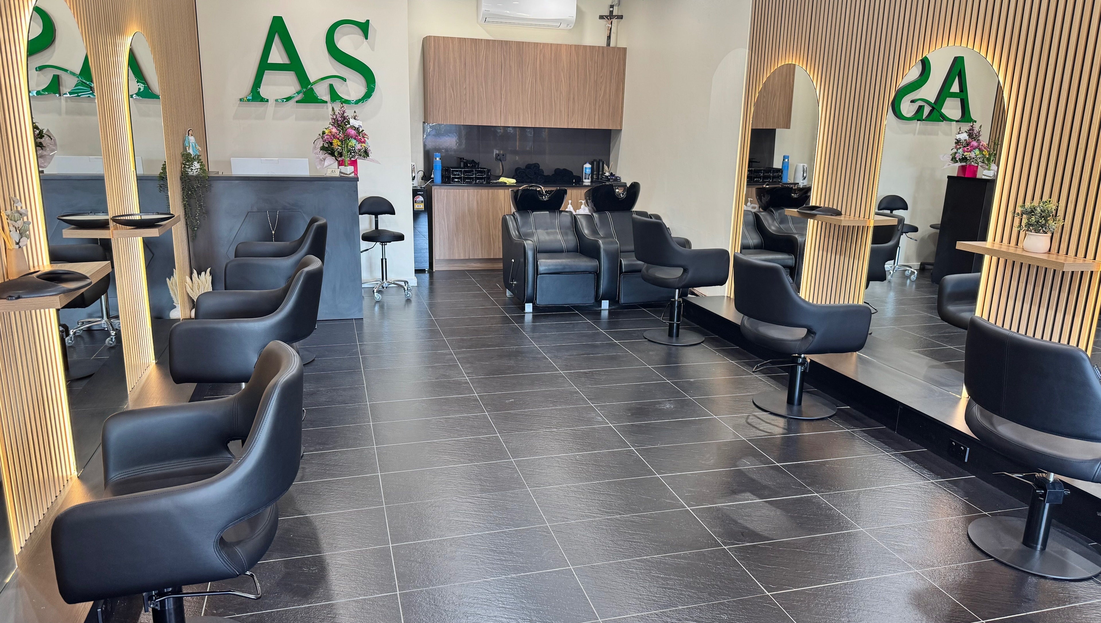 ADESSA SALON's sleek interior in Merrylands West, New South Wales, AU showcasing stylish black chairs and elegant mirrors.