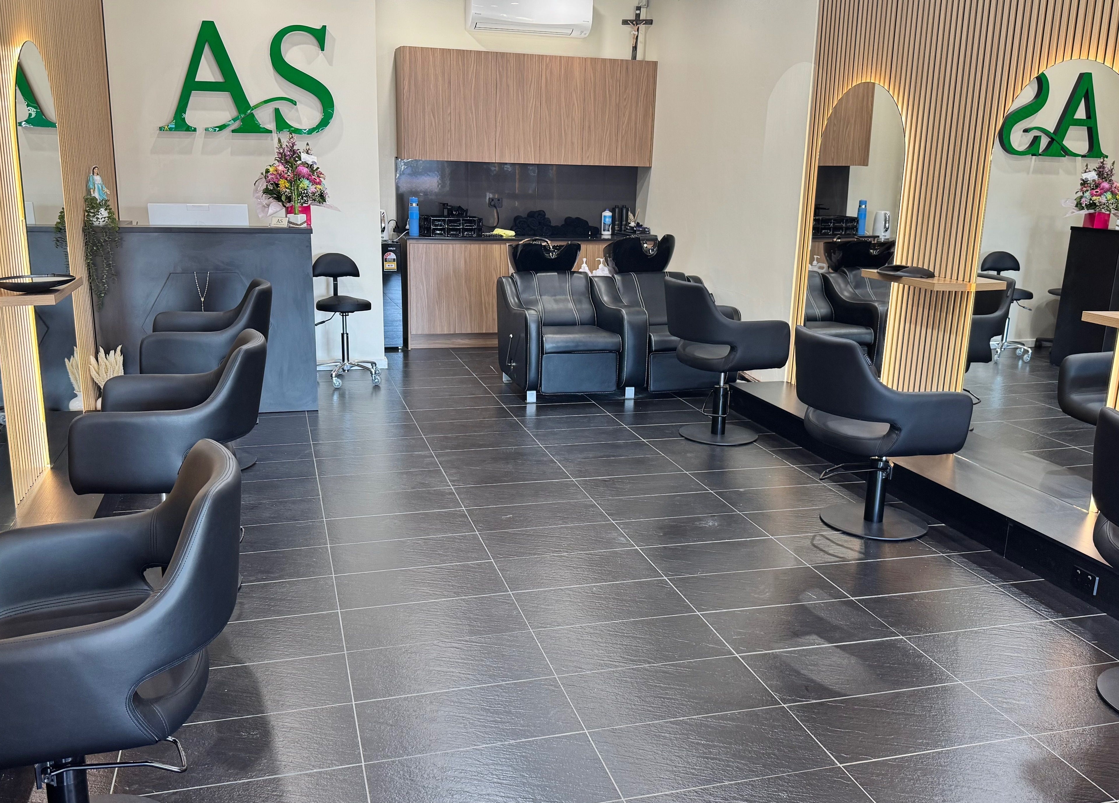 ADESSA SALON's sleek interior in Merrylands West, New South Wales, AU showcasing stylish black chairs and elegant mirrors.