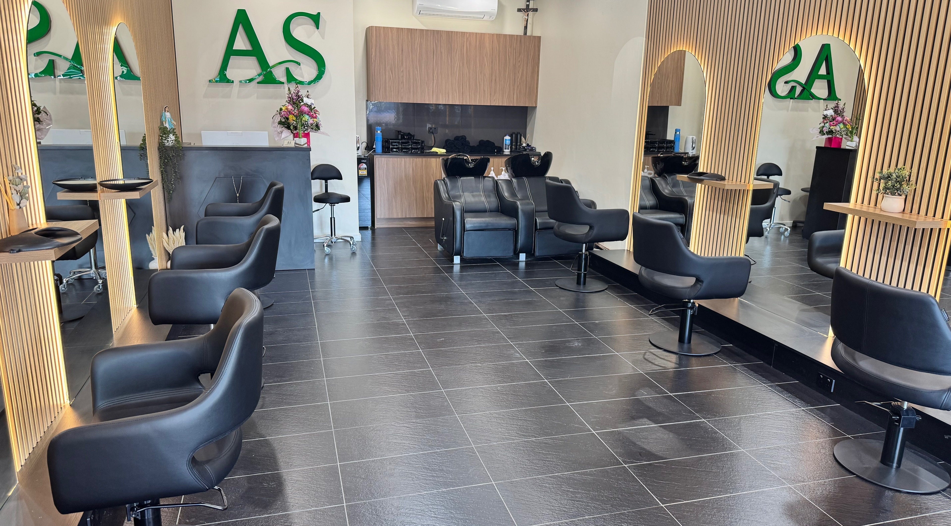 ADESSA SALON's sleek interior in Merrylands West, New South Wales, AU showcasing stylish black chairs and elegant mirrors.