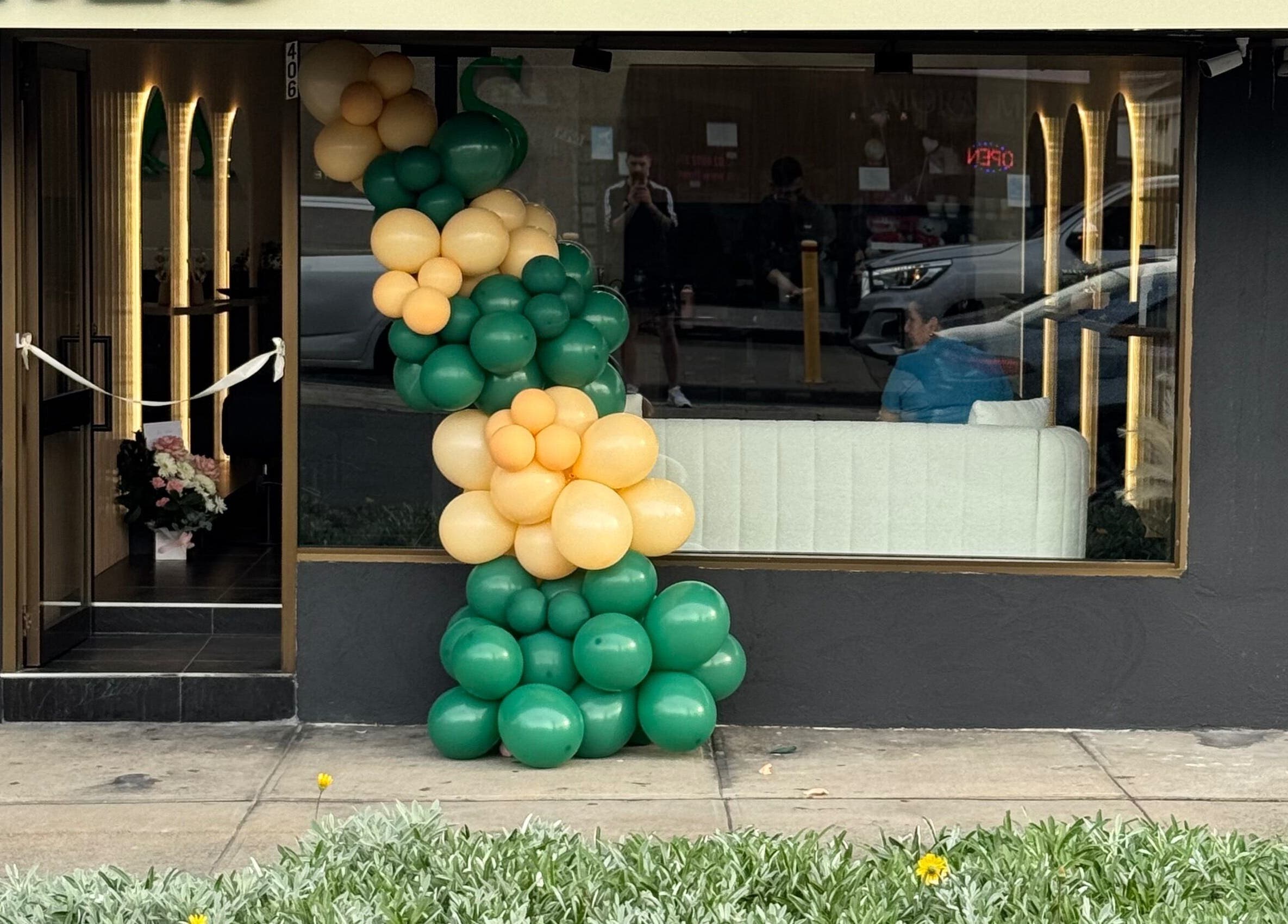 ADESSA SALON entrance with green and gold balloons in Merrylands West, New South Wales, AU.