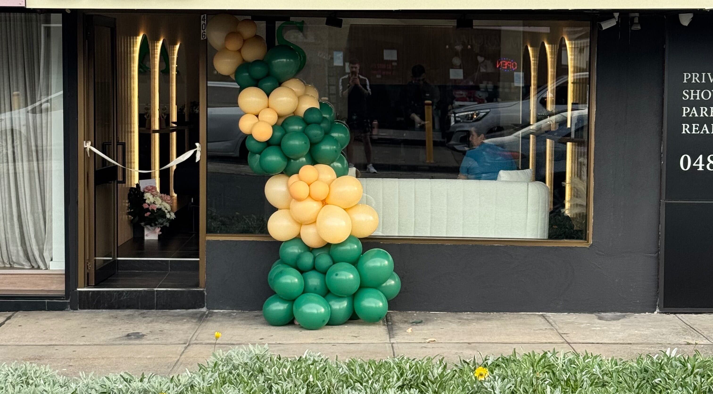ADESSA SALON entrance with green and gold balloons in Merrylands West, New South Wales, AU.