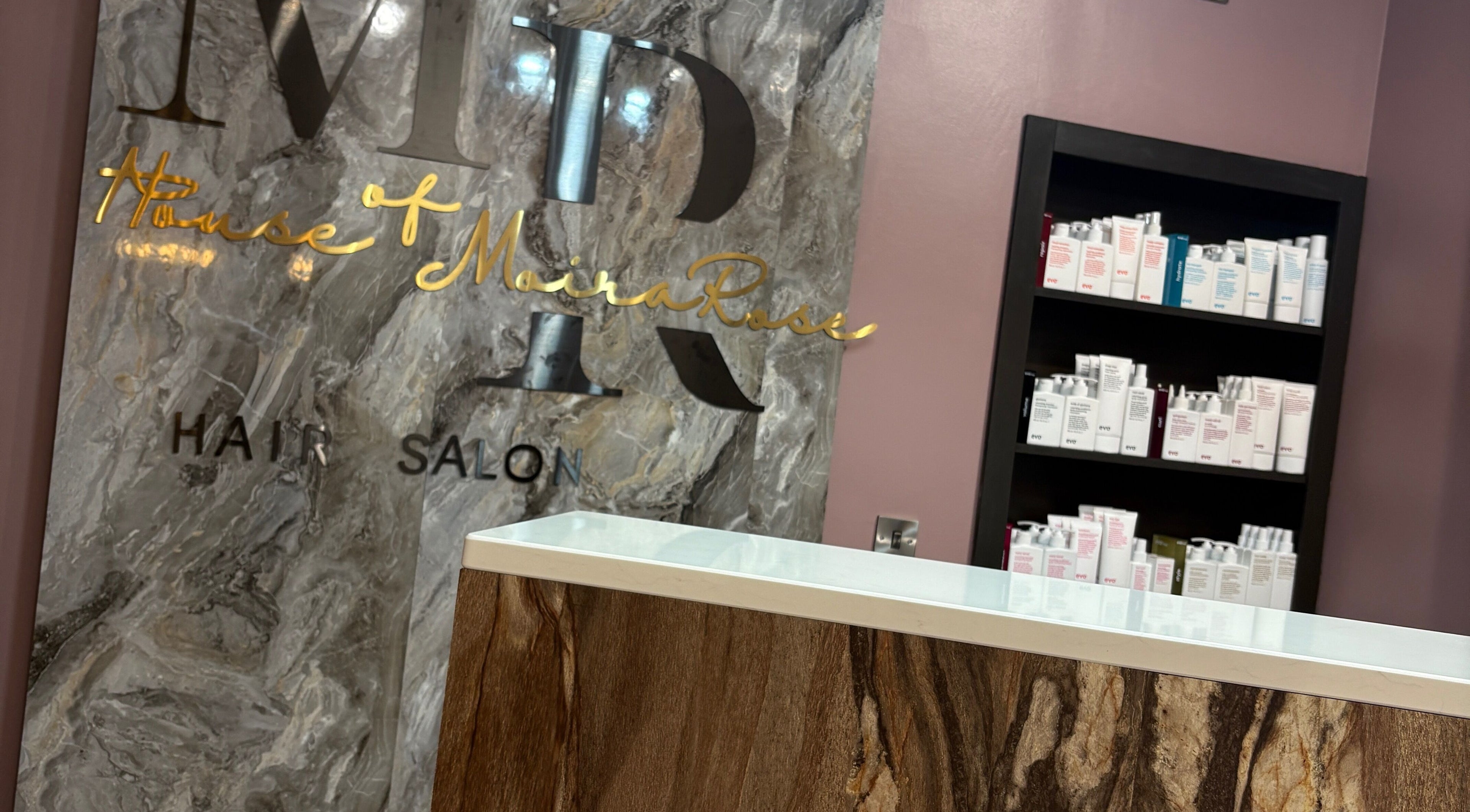 Reception area at House of Moira Rose, Thirsk, England, GB, featuring marble and stocked shelves.