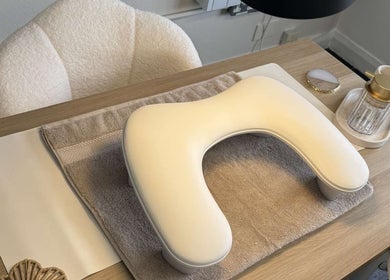 Elegant nail station at Nailsbyxanth, Nantwich, England. Features a plush chair and manicure pillow for client comfort.