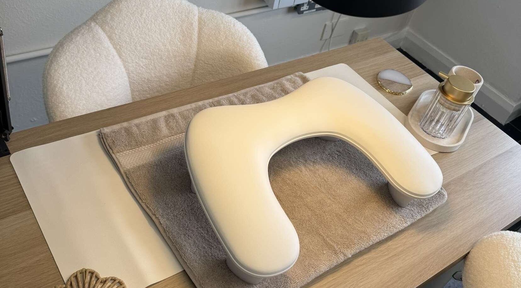 Elegant nail station at Nailsbyxanth, Nantwich, England. Features a plush chair and manicure pillow for client comfort.