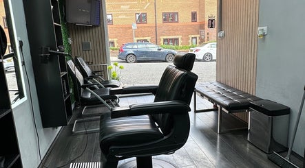 Sleek interior of Smartcut salon in Luton, England, GB, showcasing stylish black barber chairs and modern decor.