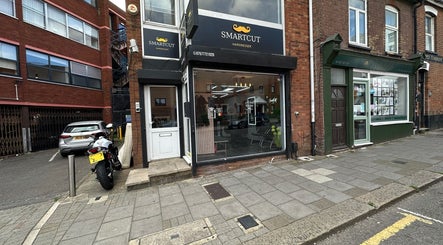 Front of Smartcut hairdresser in Luton, England, GB, showcasing modern street view.