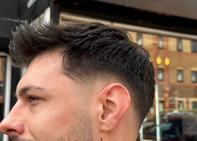 Close-up of a stylish haircut from Smartcut, Luton, England, GB showcasing precise fade technique.