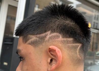 Intricate hair design at Smartcut, Luton, England, GB, showcasing unique shaved patterns.