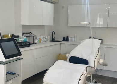 Cosmedocs treatment room in London, England, GB, featuring sleek white design and state-of-the-art equipment.