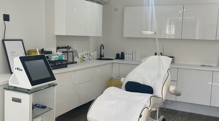 Cosmedocs treatment room in London, England, GB, featuring sleek white design and state-of-the-art equipment.
