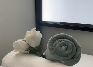 Rolled towel and roses for relaxation at Oasis of Elegance, Lusaka, Lusaka Province, ZM.