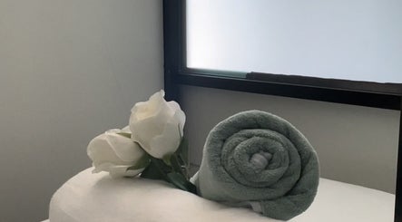 Rolled towel and roses for relaxation at Oasis of Elegance, Lusaka, Lusaka Province, ZM.