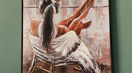 Elegant painting of a woman relaxing in Oasis of Elegance, Lusaka, Lusaka Province, ZM with a drink.