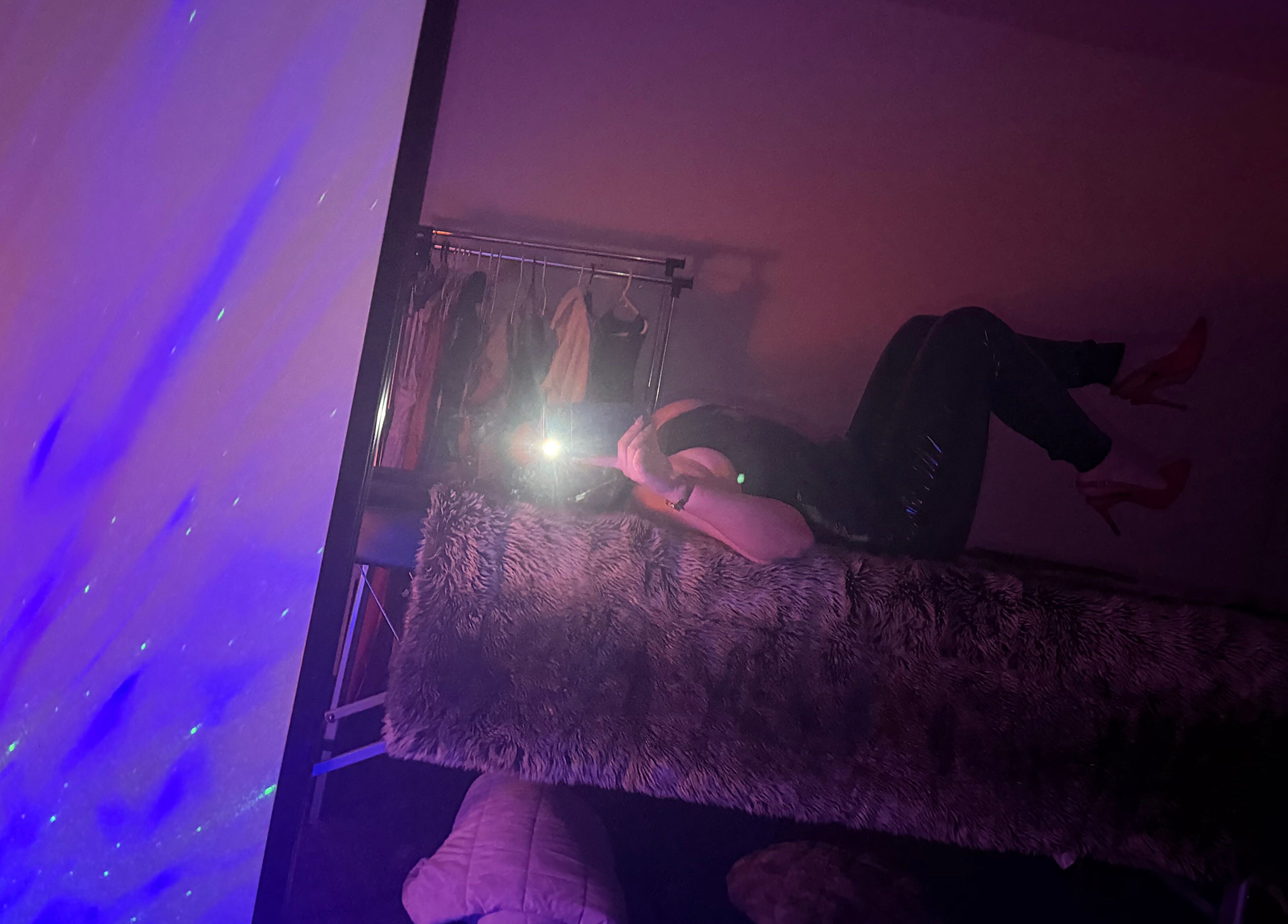 Cozy interior of Tays sensory massage in Swansea, Wales, GB with purple ambient lighting and plush decor.