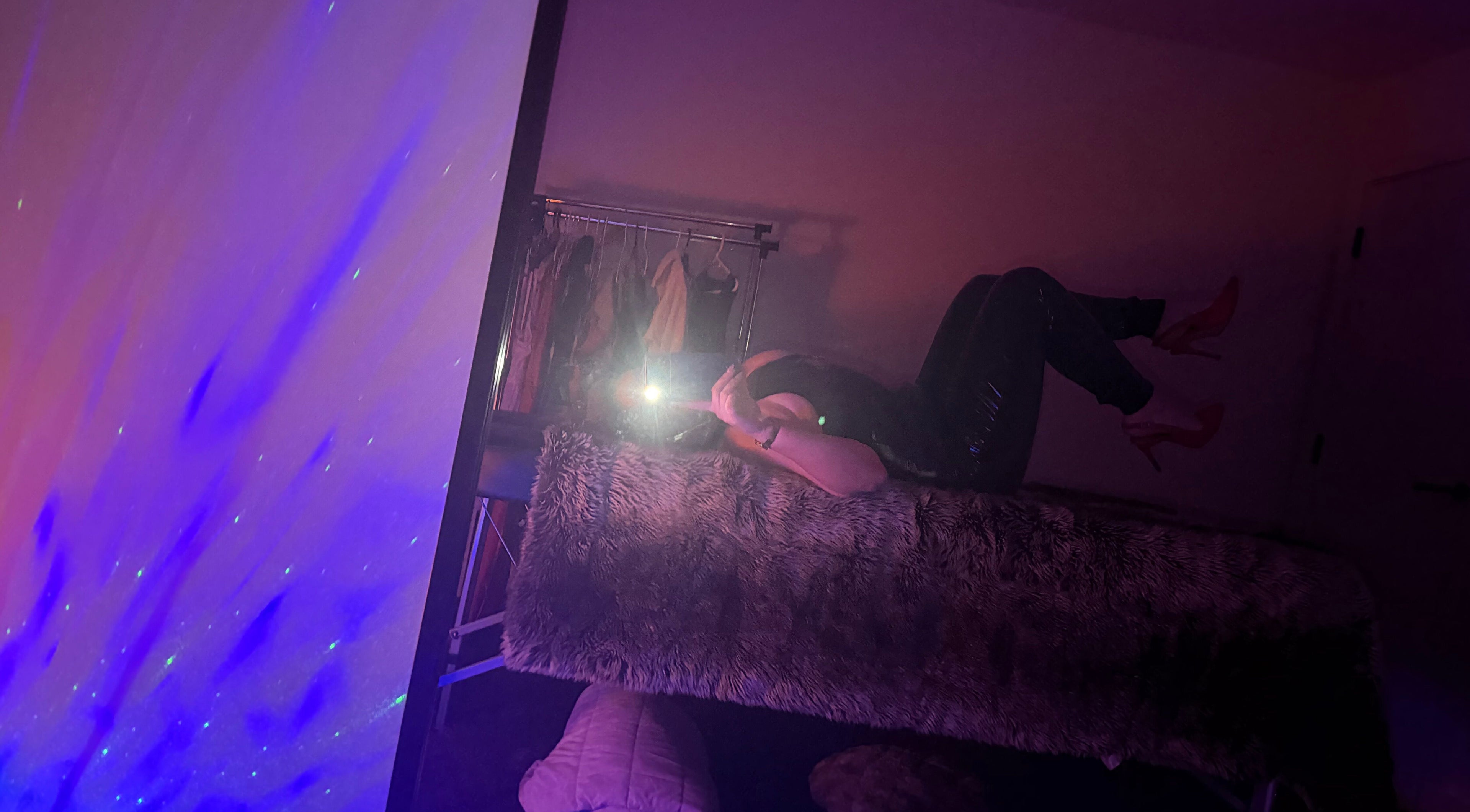 Cozy interior of Tays sensory massage in Swansea, Wales, GB with purple ambient lighting and plush decor.