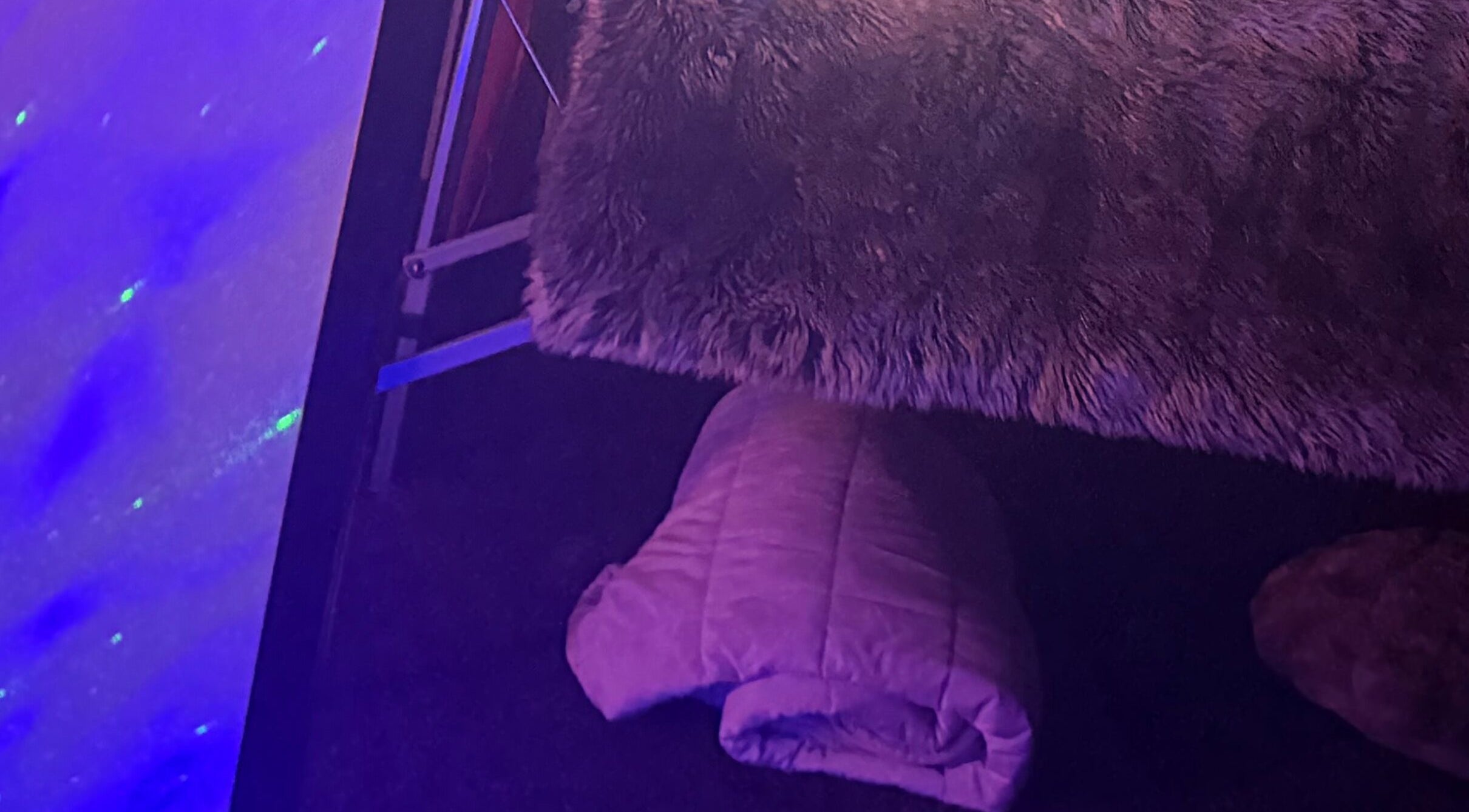 Comfortable massage table at Tays Sensory Massage, Swansea, Wales, GB with ambient lighting.