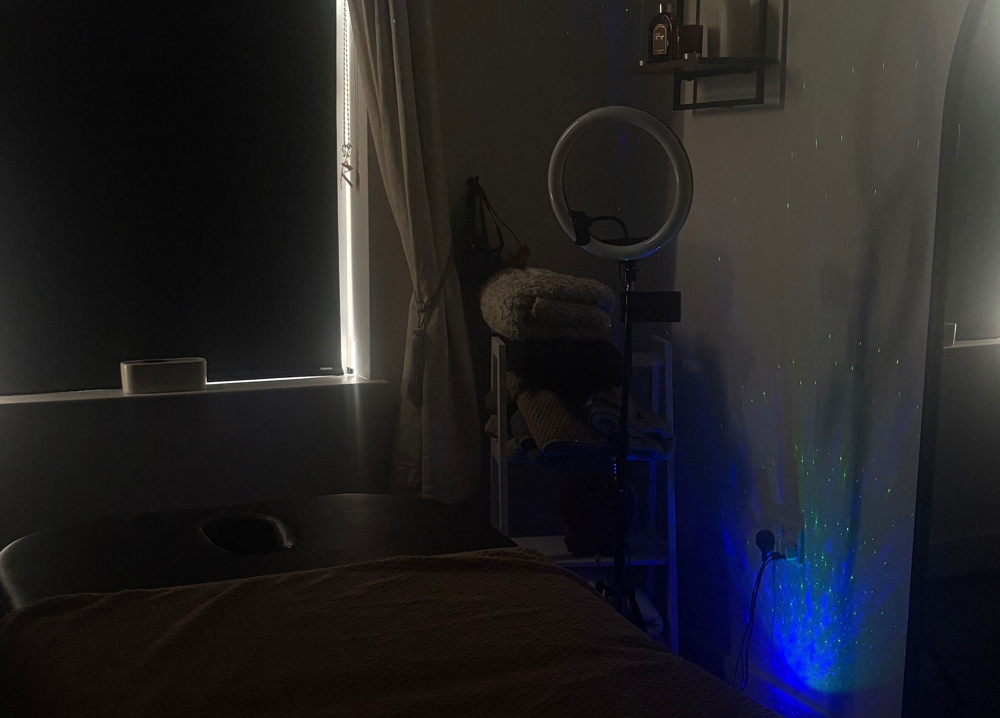 Dimly lit massage room at Tays Sensory Massage in Swansea, Wales, GB, with cozy atmosphere and relaxing ambiance.