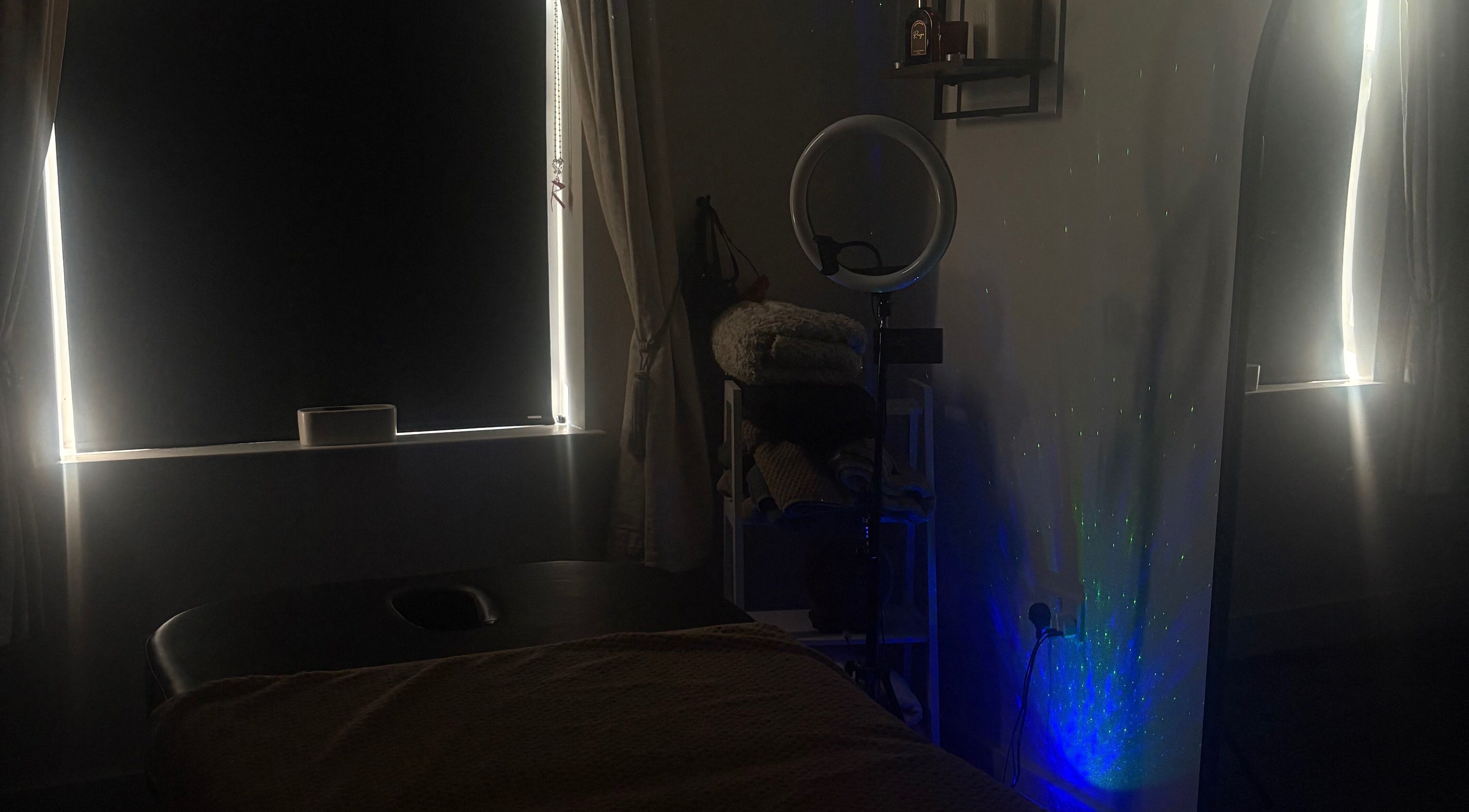 Dimly lit massage room at Tays Sensory Massage in Swansea, Wales, GB, with cozy atmosphere and relaxing ambiance.