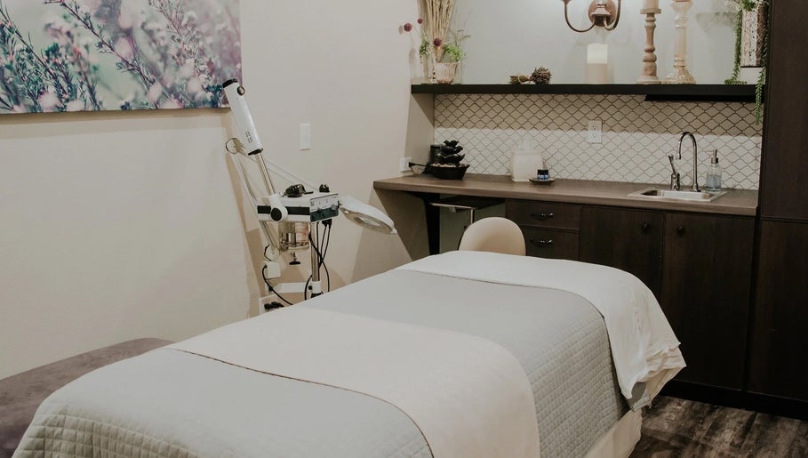 Cozy treatment room at Tenacity Rose Aesthetics in Hyrum, Utah, US, featuring a plush bed and serene decor.