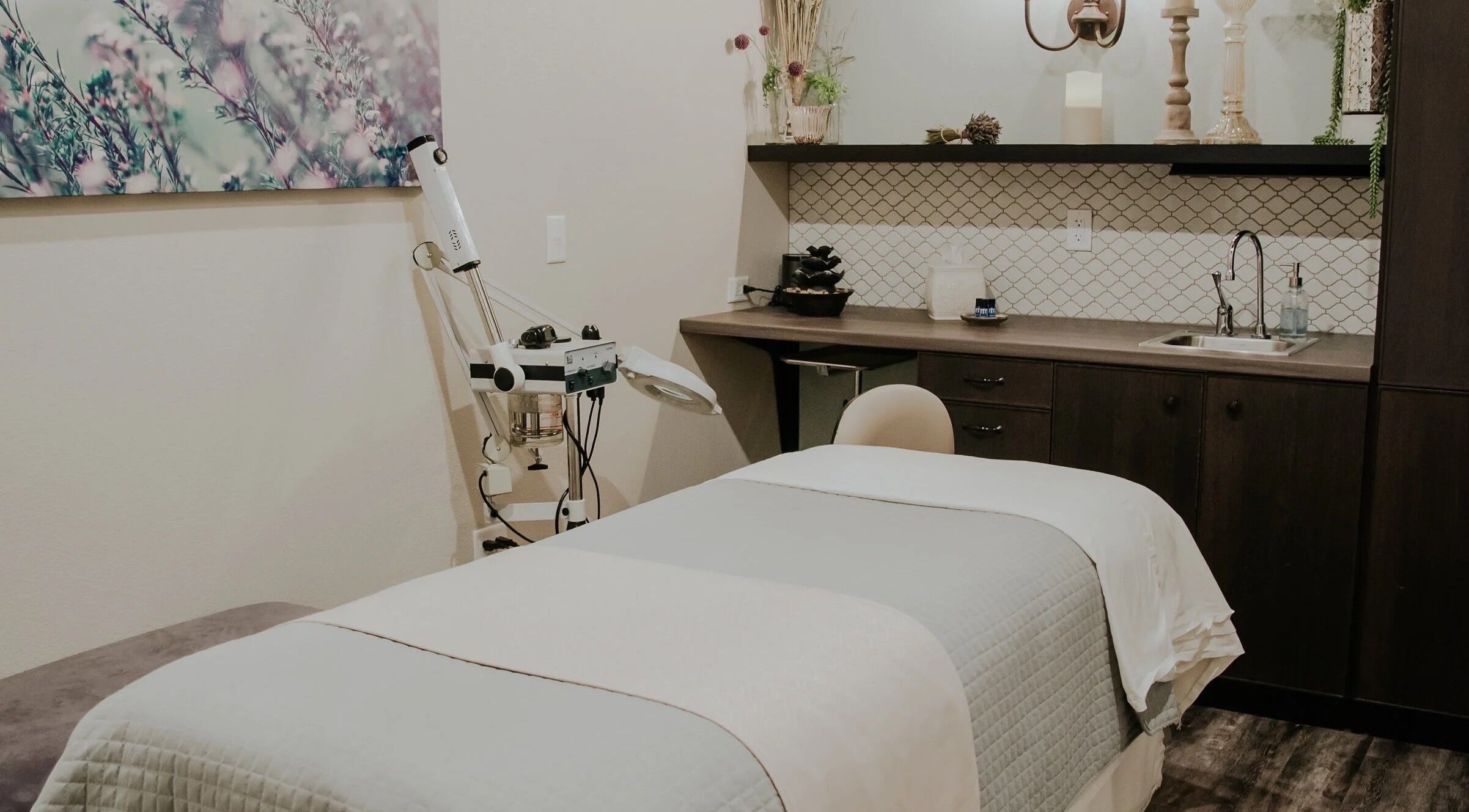 Cozy treatment room at Tenacity Rose Aesthetics in Hyrum, Utah, US, featuring a plush bed and serene decor.