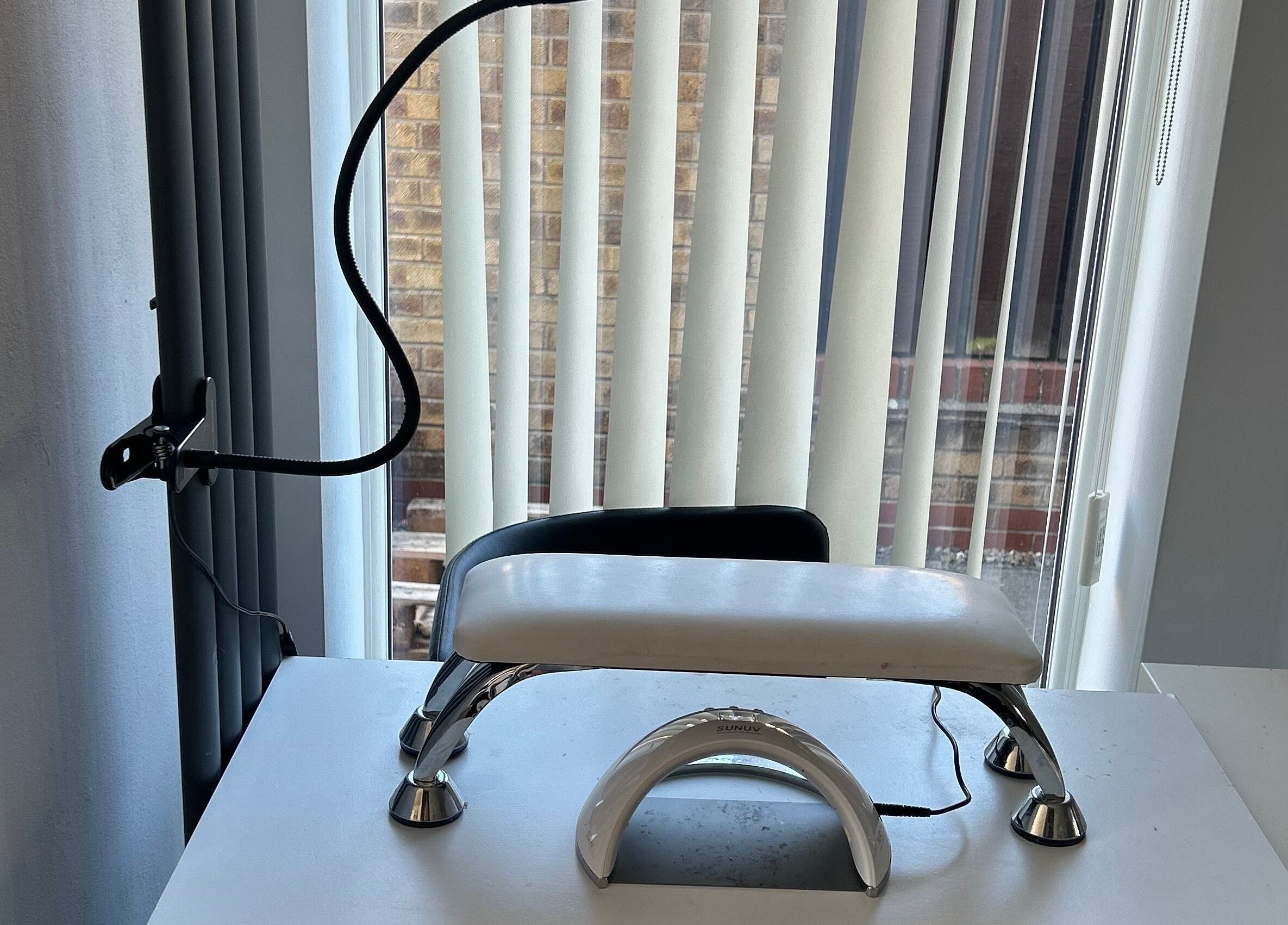 Modern nail station at ghnailsx in Huntington, England, GB with elegant lighting and sleek design.