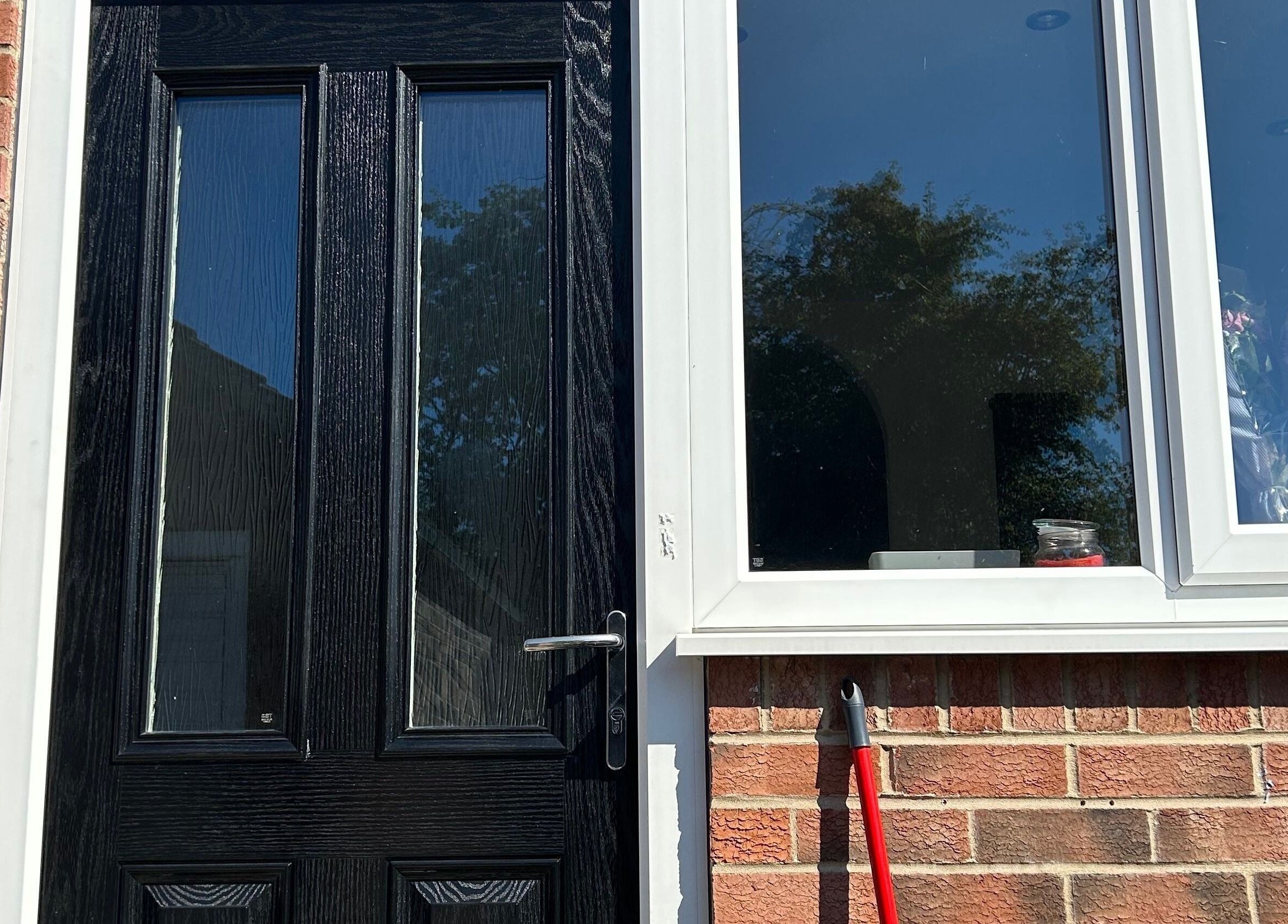 Black door and window at ghnailsx, Huntington, England, GB.