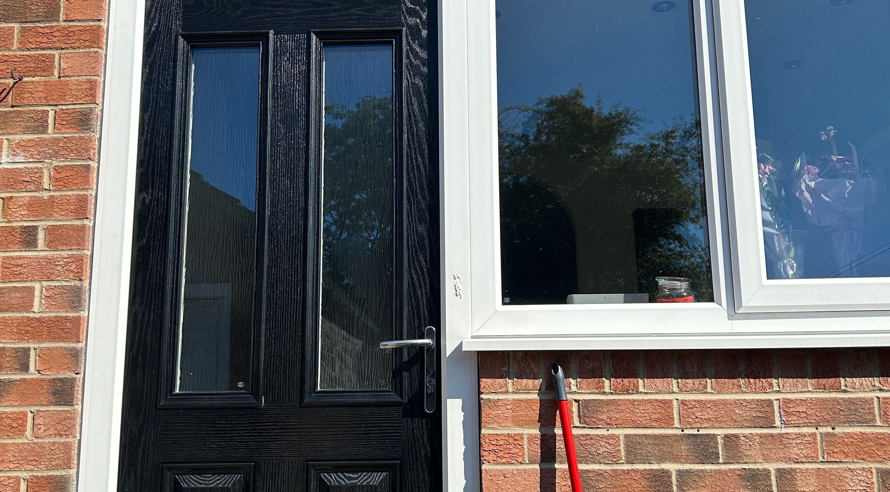 Black door and window at ghnailsx, Huntington, England, GB.