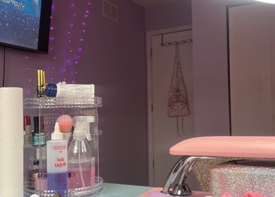 Cozy nail station at nailsxbrianni, Justice, Illinois. Pink decor and nail supplies create a welcoming atmosphere.