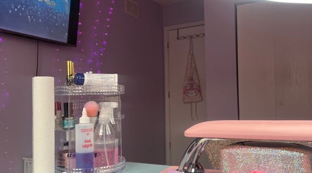 Cozy nail station at nailsxbrianni, Justice, Illinois. Pink decor and nail supplies create a welcoming atmosphere.