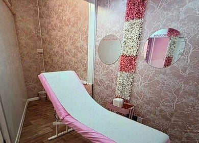 Elegant treatment room at SkinbyTBI, Hornchurch, England, GB, featuring pink decor and floral accents.