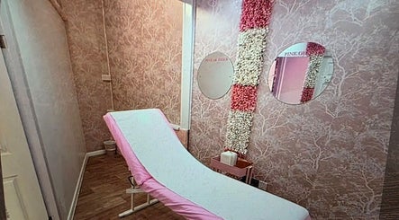 Elegant treatment room at SkinbyTBI, Hornchurch, England, GB, featuring pink decor and floral accents.