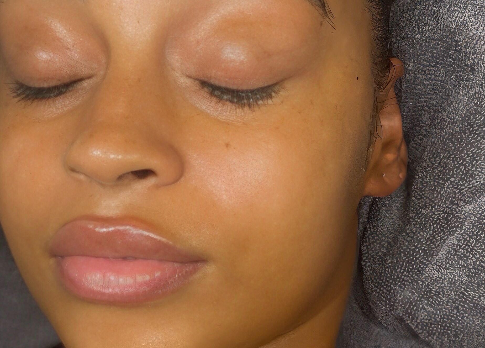 Close-up of a serene face with glowing skin at My Way Beauty, London, England, GB.