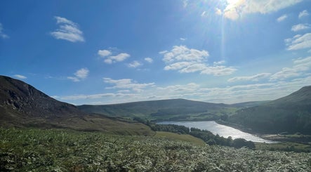 Peaceful hillside near Skinfixuk, Manchester, England, GB, with clear sky and scenic views.