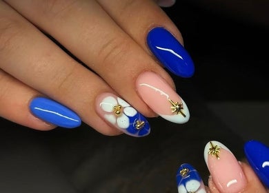 Stylish blue and pink nail art at Pink Muse, Aberdeen, Scotland, GB with intricate gold accents.