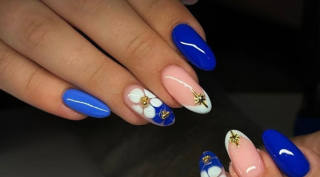 Stylish blue and pink nail art at Pink Muse, Aberdeen, Scotland, GB with intricate gold accents.