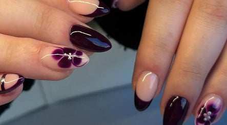 Elegant floral nail art in deep purple at Pink Muse, Aberdeen, Scotland, GB, showcasing intricate design details.