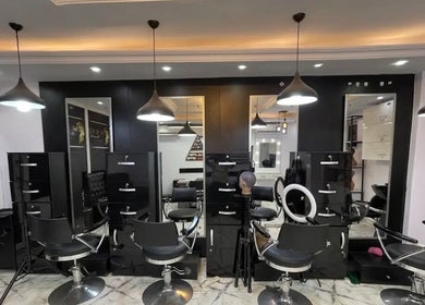 Modern salon interior at Timi Hairtertainment, Lekki, Lagos, NG, showcasing sleek chairs and mirrors.