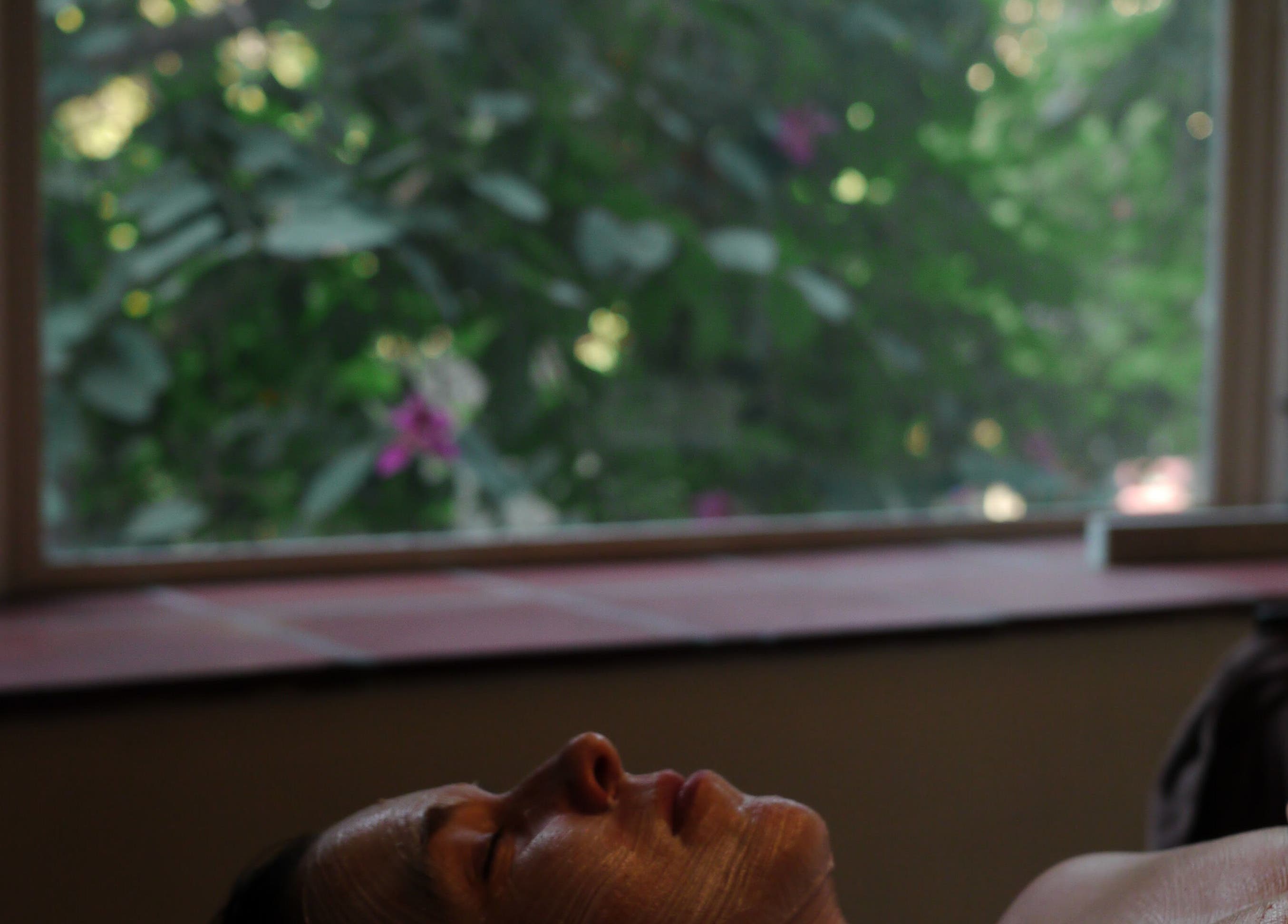 Relaxing facial at Theresa Irene Esthetics with lush greenery in Long Beach, California, US.