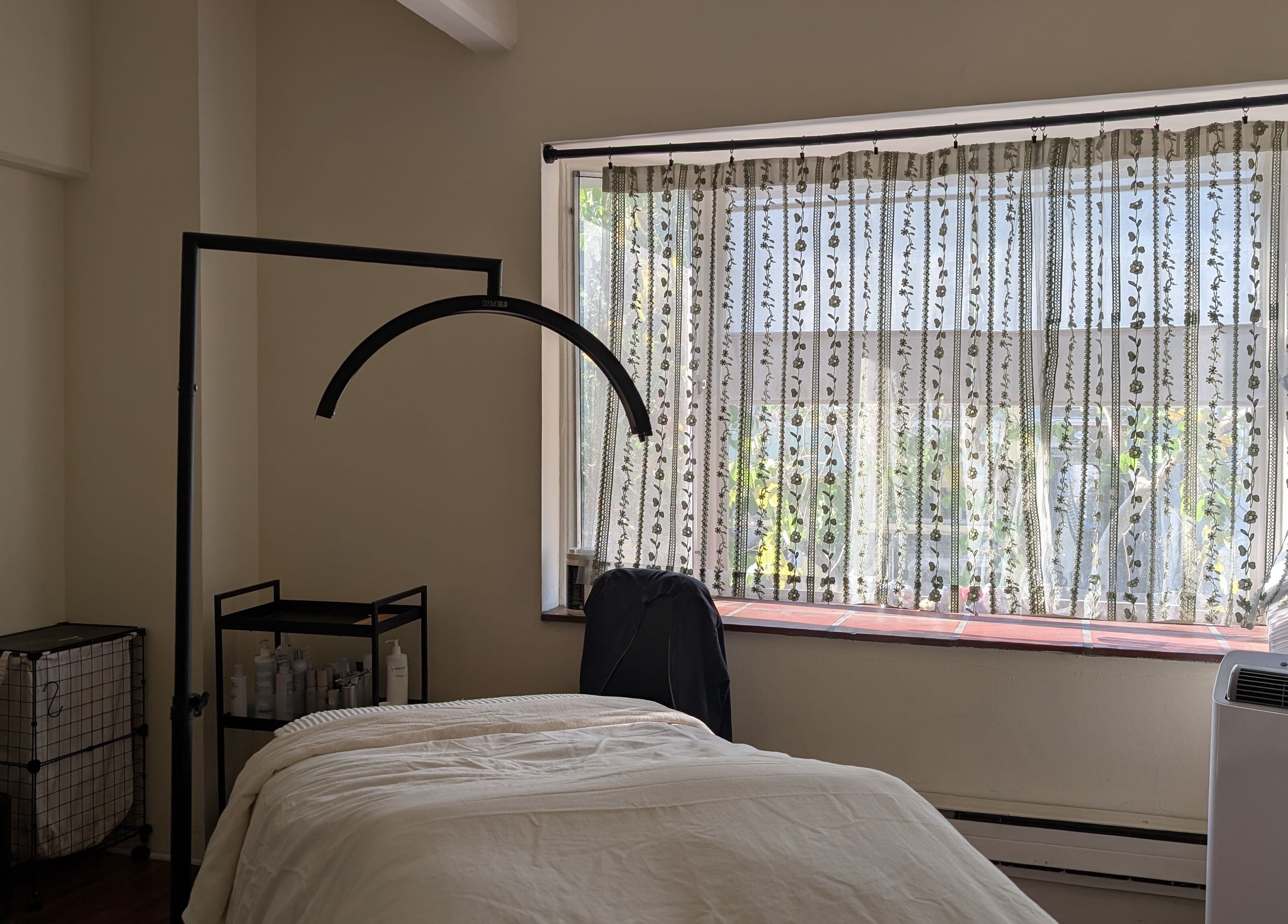 Theresa Irene Esthetics treatment room with soft lighting in Long Beach, California, US.