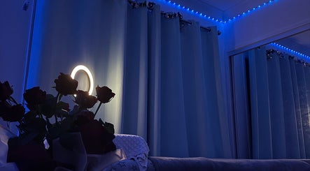 Cozy blue-lit room with flowers at Chic Beauty Studio, Landsborough, Queensland, AU.