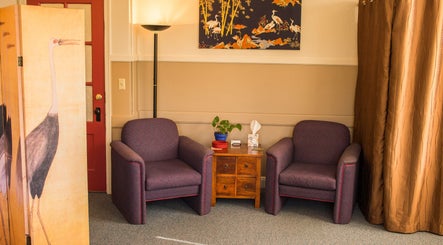 Inviting seating area at Taller De Lo Invisible, Portland, Oregon, US with armchairs and vibrant decor.