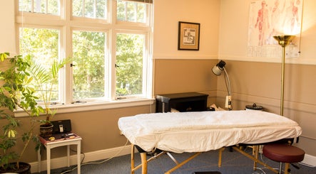 Tranquil therapy room at Taller De Lo Invisible (Atelier of the Invisible) in Portland, Oregon, US, with massage bed.