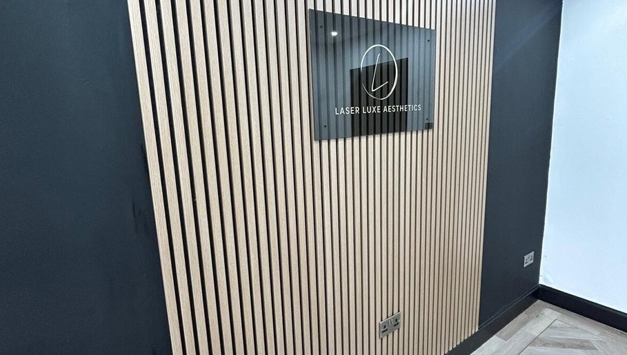 Modern wall and sign at Laser Luxe Aesthetics, Glasgow, Scotland, GB, showcasing sleek design.