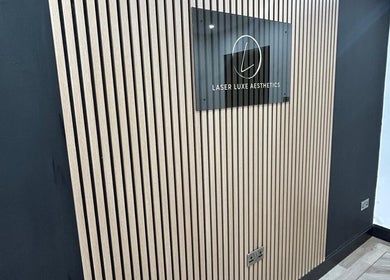 Modern wall and sign at Laser Luxe Aesthetics, Glasgow, Scotland, GB, showcasing sleek design.