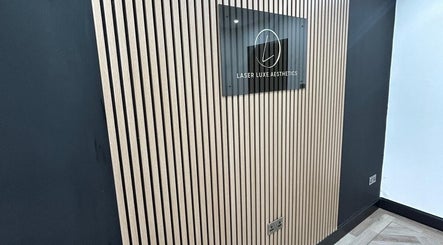 Modern wall and sign at Laser Luxe Aesthetics, Glasgow, Scotland, GB, showcasing sleek design.