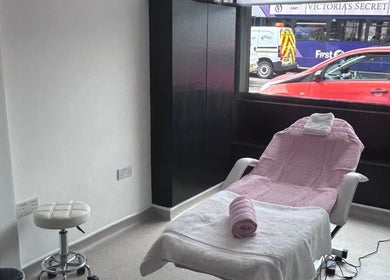 Relaxing treatment room at Laser Luxe Aesthetics in Glasgow, Scotland, GB, featuring a pink-draped chair.