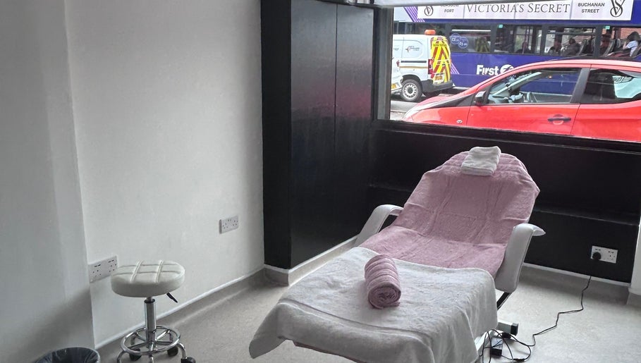 Relaxing treatment room at Laser Luxe Aesthetics with pink-draped chair, Glasgow, Scotland, GB.